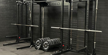 xpeed alpha half racks in a gym with weights and barbells