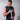 Athlete wrapping his hands with white xpeed wrist wraps against a white brick wall.