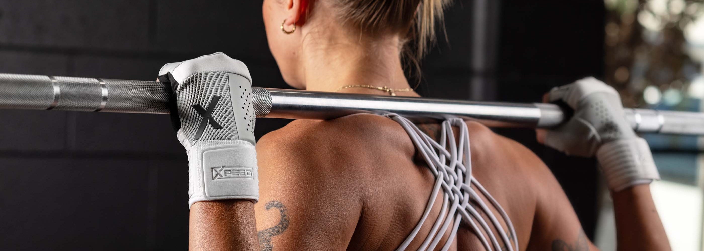 Female athlete using Xpeed Hybrid Training Gloves for back squats