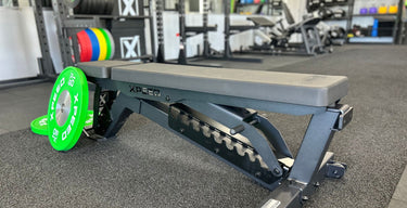 an xpeed adjustable bench sits on a gym floor