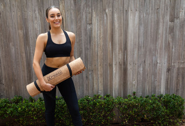 Malissa Fedele holding a cork Xpeed yoga mat