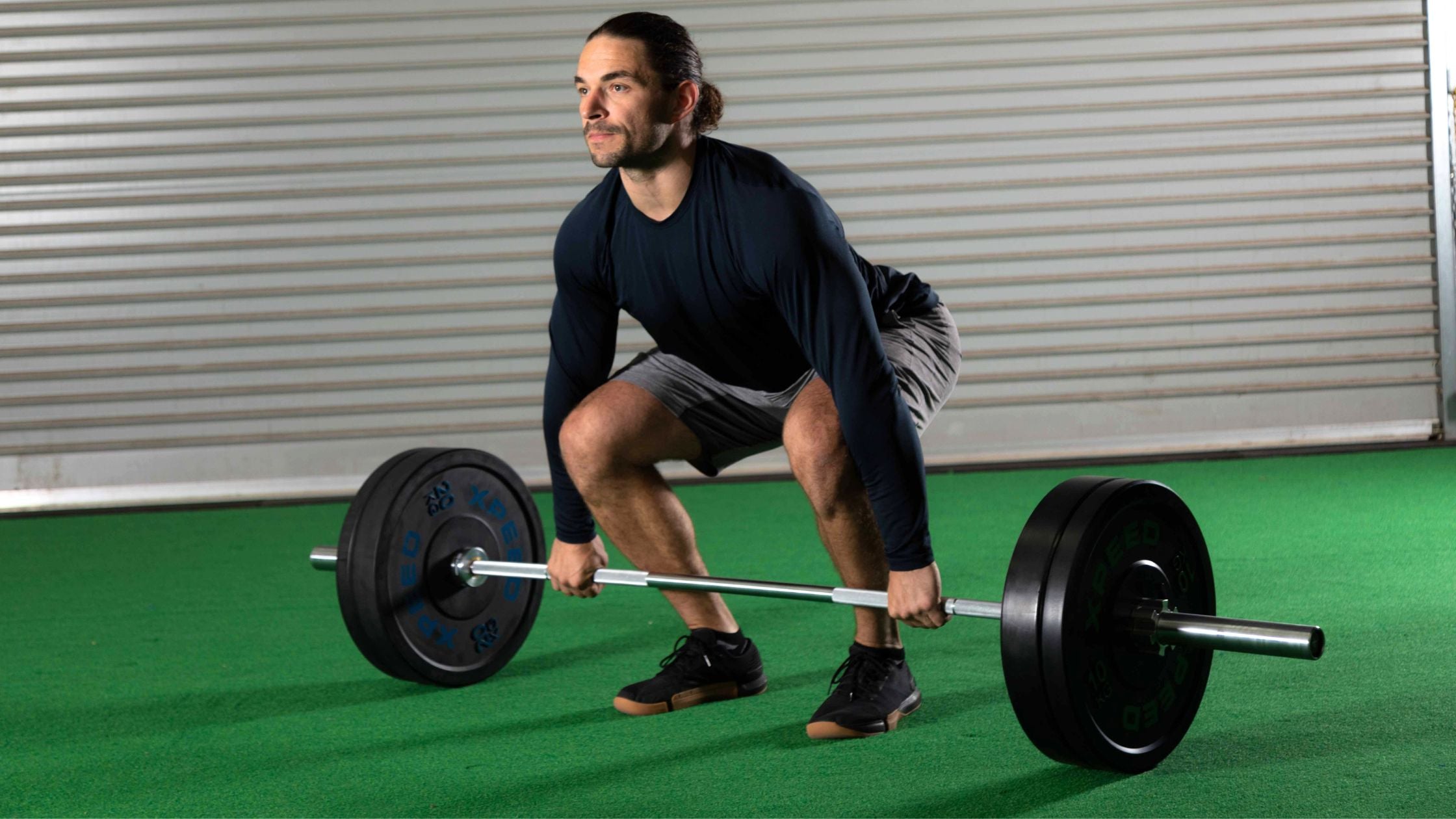 Man performing the deadlift exercise with an xpeed barbell