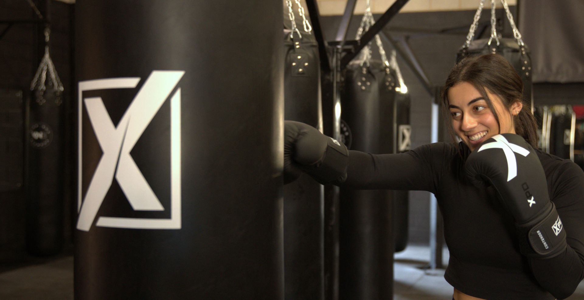 Female athlete training with Xpeed boxing bag in boxing class