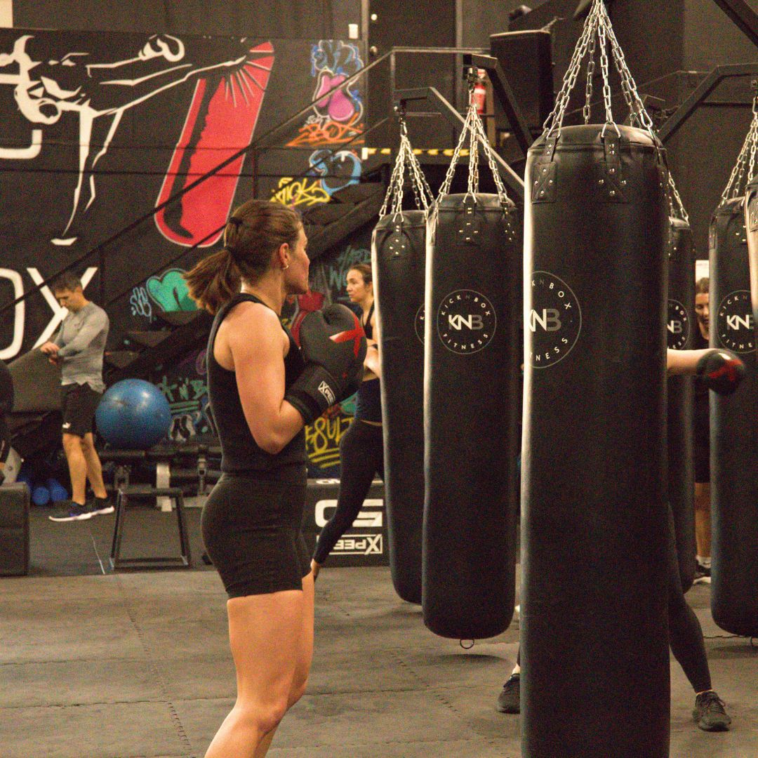 An athlete trains on a custom xpeed boxing bag whilst wearing xpeed boxing gloves