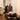 Person using a Pilates reformer machine in a home setting.