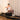Woman using a Pilates reformer machine in a home setting.