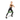 A woman in a black athletic tank top and leggings is performing a lunge exercise while wearing a green resistance band around her legs, isolated on a white background.