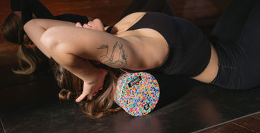 an Xpeed medium density foam roller being used in a yoga class