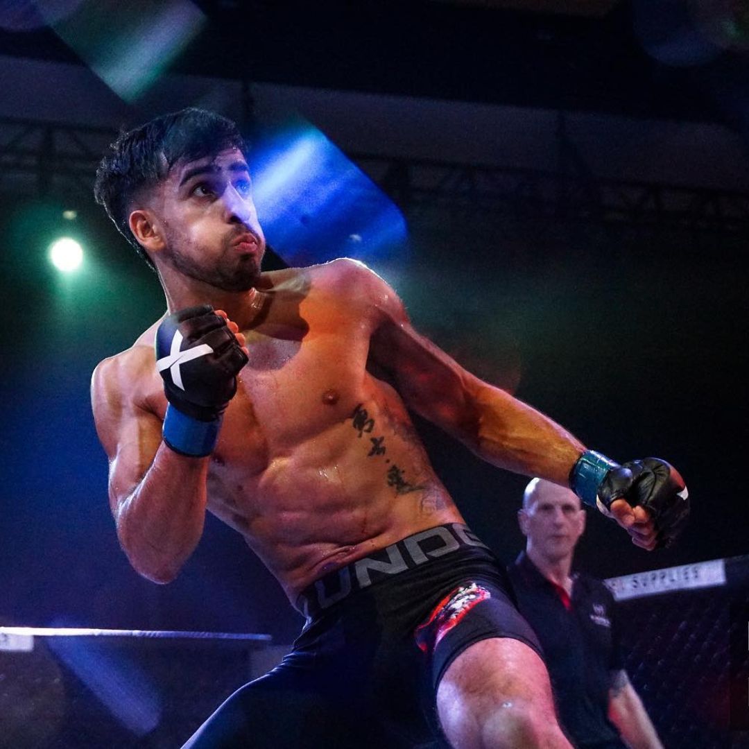 MMA fighter takes on his opponent in Xpeed MMA Gloves