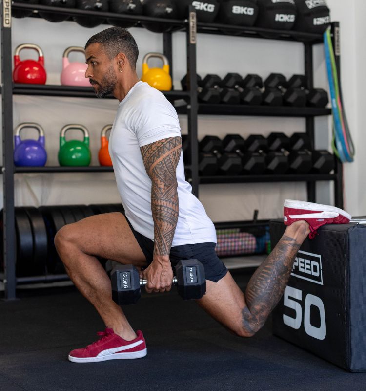 man using xpeed reubber hex dumbbells in his dream garage gym