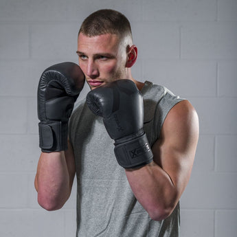 An athlete training with matte black professional boxing mitts